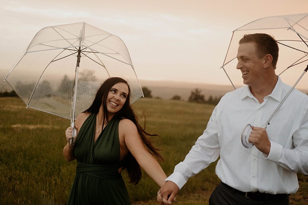 engagement photos under umbrella walking in the rain