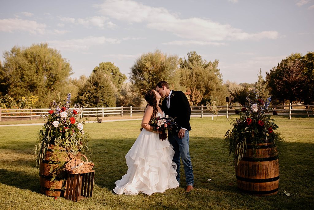 couple kissing during pictures at their backyard wedding