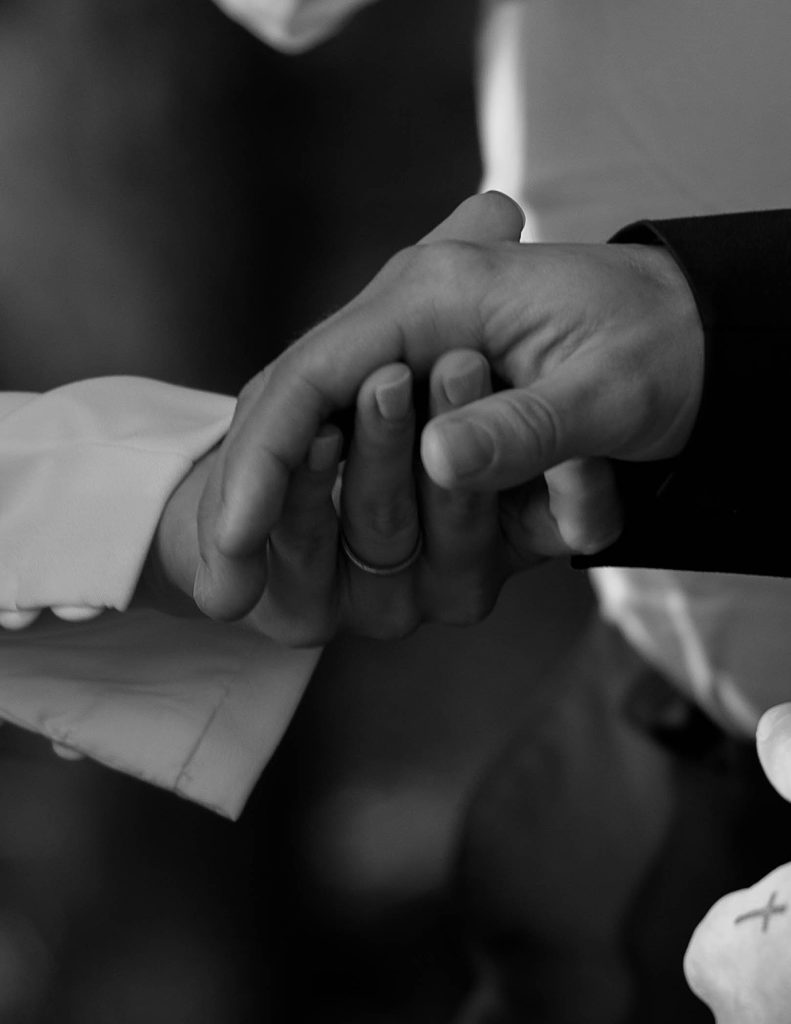 bride and groom holding hands at wedding ceremony
